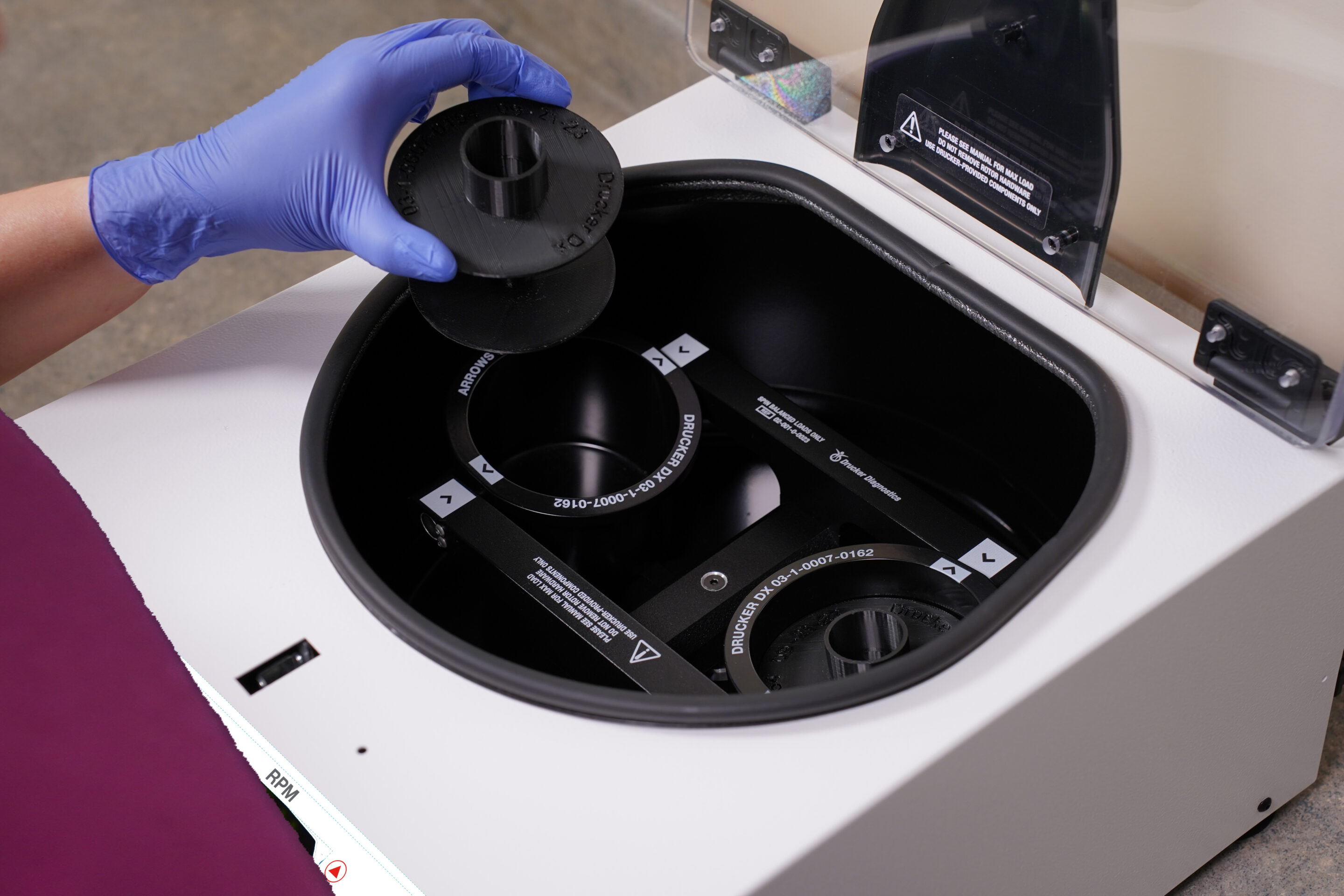 A centrifuge insert for a 50 mL tube is placed into the wide capacity BOOST 2+ Max bucket
